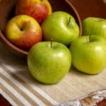 green apple on white table cloth