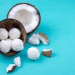 a half eaten coconut and pieces of coconut on a blue background
